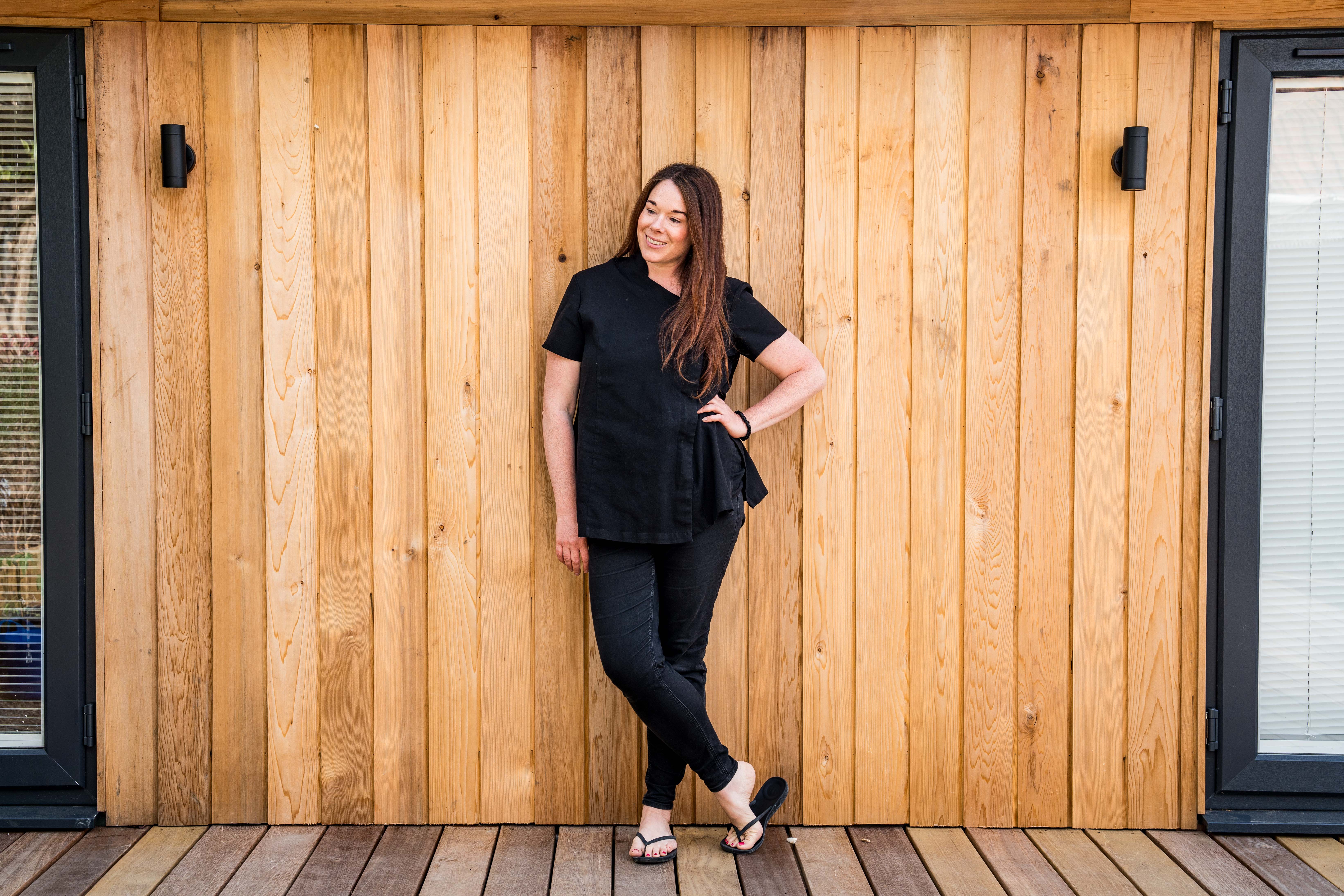 Emma Blakeman standing outside her garden studio